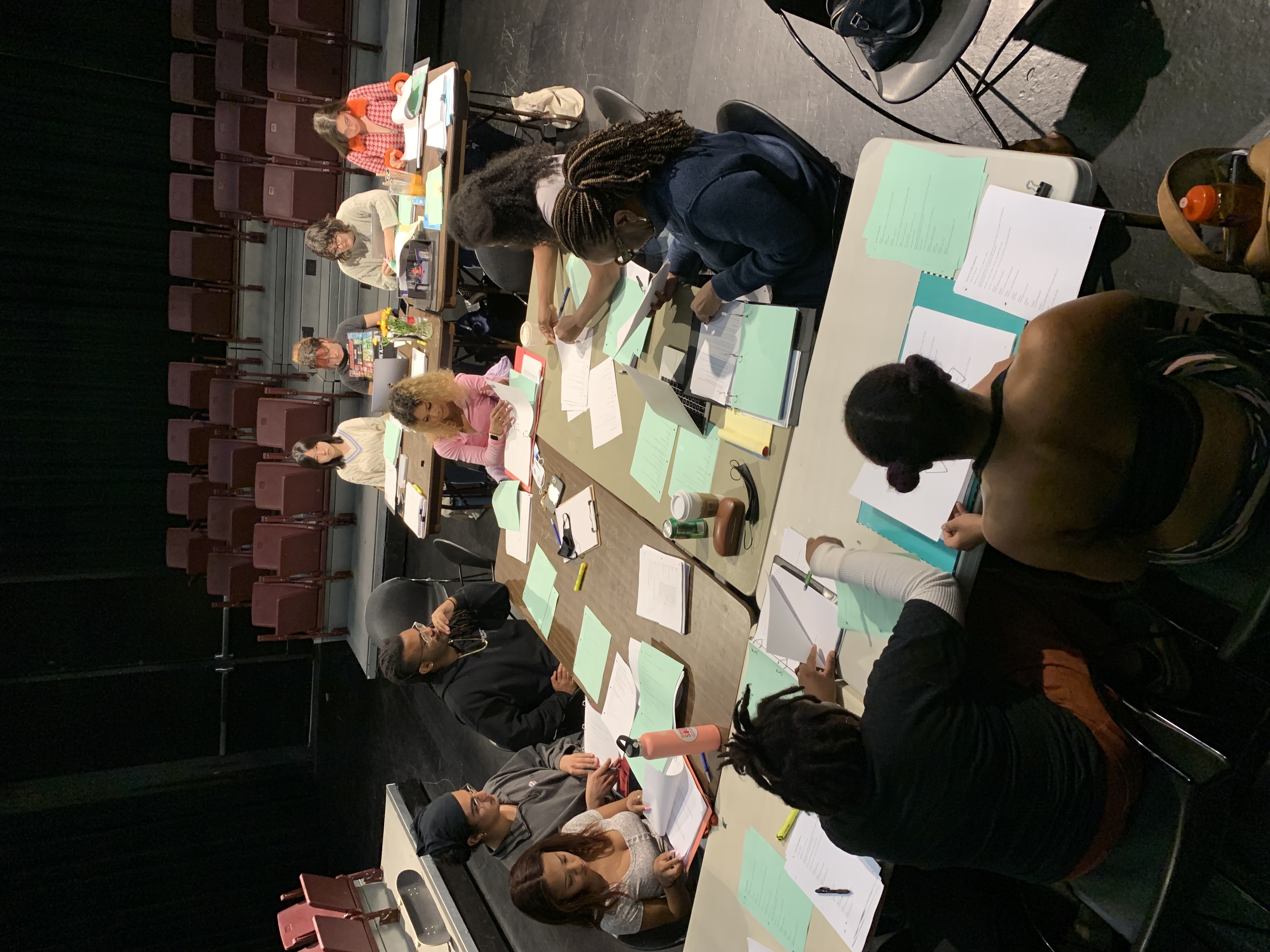 overview shot of cast working at the table